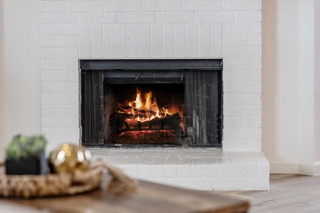 3300 Jacobs Dr, Mckinney, TX 75070 - detailed view of a warm lit fireplace and wood finished floors