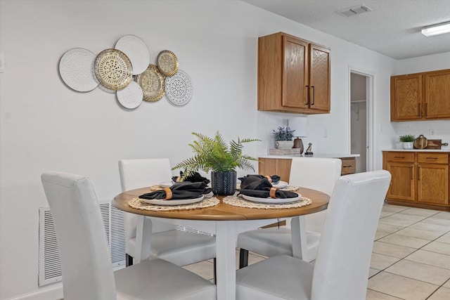 3300 Jacobs Dr, Mckinney, TX 75070 - dining space with light tile patterned flooring and a textured ceiling