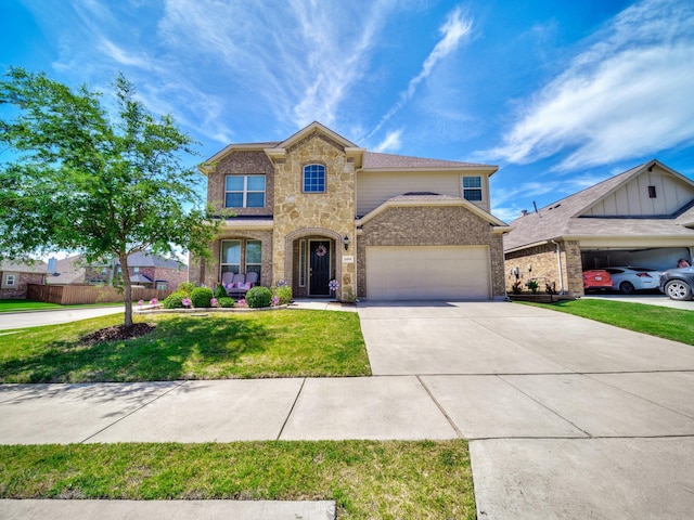 2460 Open Range Dr, Fort Worth, TX 76177 - traditional home with stone siding, an attached garage, concrete driveway, a front yard, and brick siding