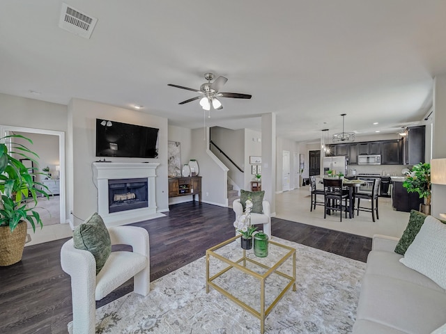 2460 Open Range Dr, Fort Worth, TX 76177 - living area featuring stairway, a fireplace with raised hearth, wood finished floors, ceiling fan, and recessed lighting