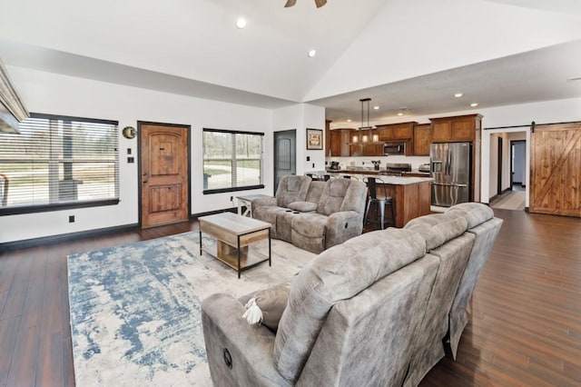 217 Polk, Bowie, TX 76230 - living area featuring a barn door, recessed lighting, dark wood-style floors, a ceiling fan, and high vaulted ceiling