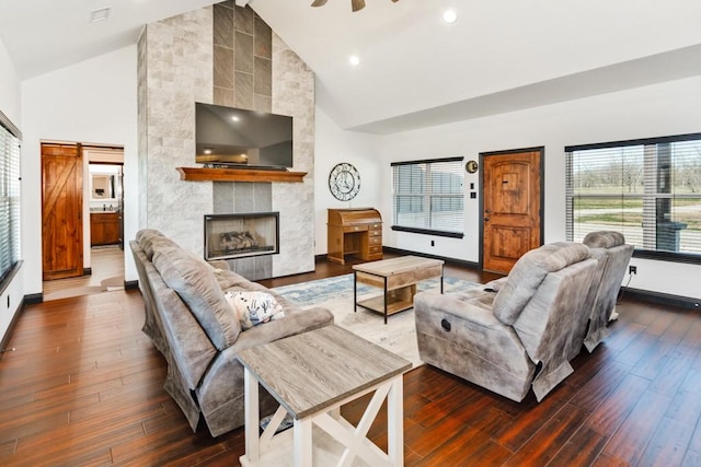 217 Polk, Bowie, TX 76230 - living area with high vaulted ceiling, dark wood-type flooring, a fireplace, and recessed lighting