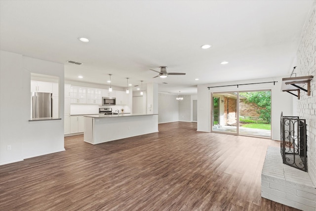 8620 S County Rd, Frisco, TX 75034 - unfurnished living room with wood finished floors, a ceiling fan, recessed lighting, and a chandelier