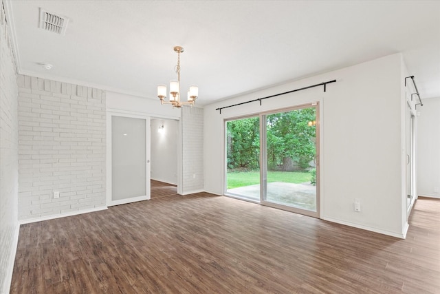 8620 S County Rd, Frisco, TX 75034 - spare room with brick wall, wood finished floors, and a chandelier