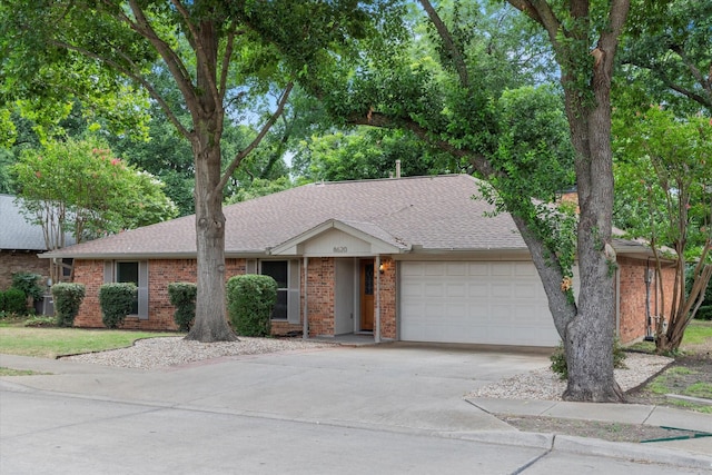 8620 S County Rd, Frisco, TX 75034 - view of front of house with an attached garage, concrete driveway, brick siding, and a shingled roof