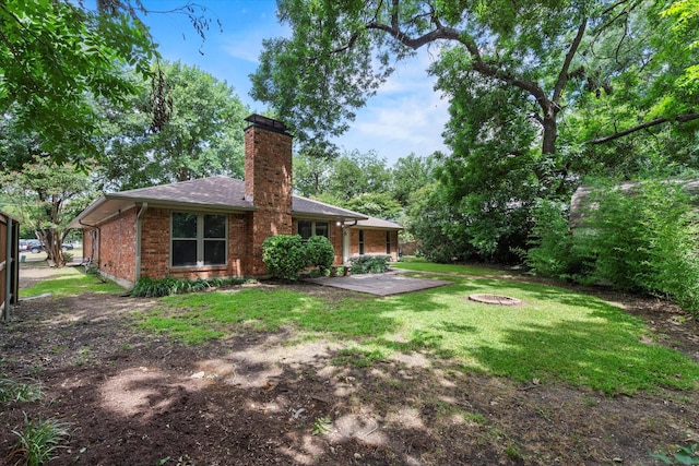 8620 S County Rd, Frisco, TX 75034 - back of house featuring a patio, a chimney, brick siding, a yard, and roof with shingles
