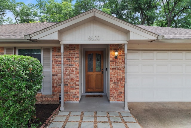 8620 S County Rd, Frisco, TX 75034 - doorway to property with a shingled roof, brick siding, a garage, and driveway