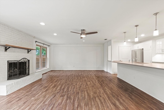 8620 S County Rd, Frisco, TX 75034 - unfurnished living room featuring dark wood finished floors, ceiling fan, recessed lighting, and a fireplace
