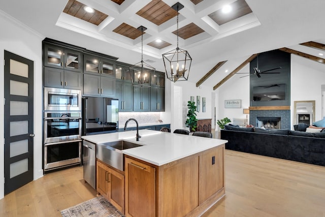 140 Friesian Ln, Waxahachie, TX 75167 - kitchen with stainless steel appliances, light wood finished floors, a ceiling fan, beamed ceiling, and backsplash