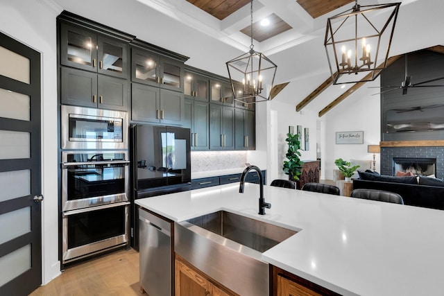 140 Friesian Ln, Waxahachie, TX 75167 - kitchen with a chandelier, light countertops, appliances with stainless steel finishes, a ceiling fan, and beamed ceiling