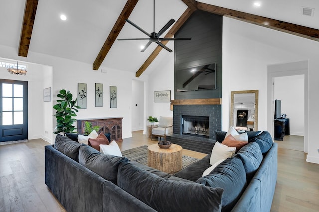 140 Friesian Ln, Waxahachie, TX 75167 - living area featuring a brick fireplace, beam ceiling, light wood finished floors, a chandelier, and recessed lighting
