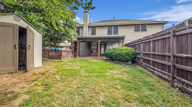 5613 Buttercup Ln, Mckinney, TX 75070 - back of property featuring a shed, a fenced backyard, a chimney, and brick siding