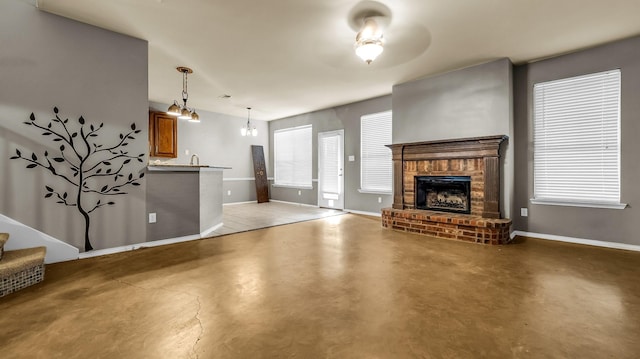 5613 Buttercup Ln, Mckinney, TX 75070 - unfurnished living room featuring concrete flooring, a fireplace, and stairs