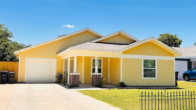 5625 Como Dr, Fort Worth, TX 76107 - view of front of house with an attached garage, covered porch, driveway, and roof with shingles
