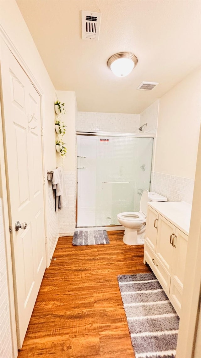 5625 Como Dr, Fort Worth, TX 76107 - full bathroom with a stall shower, wood finished floors, vanity, and a wainscoted wall