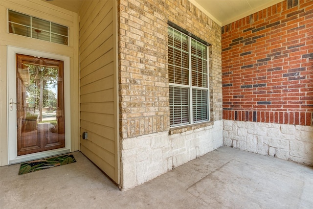 2836 Fordham Rd, Plano, TX 75025 - doorway to property with brick siding, stone siding, and a porch