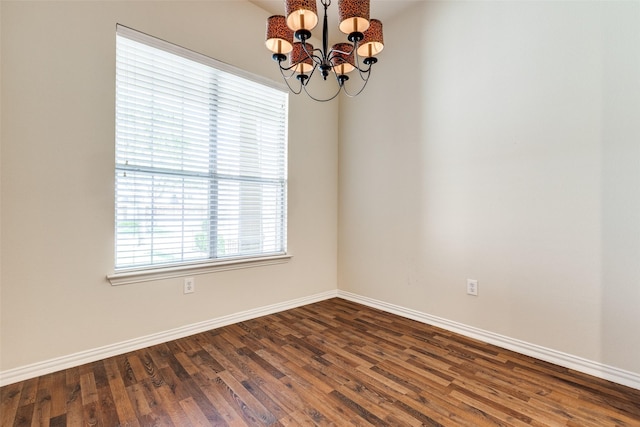 2836 Fordham Rd, Plano, TX 75025 - spare room with a chandelier and dark wood-type flooring