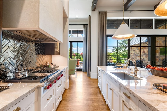 2307 Cedar Elm Ter, Westlake, TX 76262 - kitchen featuring ventilation hood, decorative backsplash, stainless steel gas stovetop, and white cabinetry