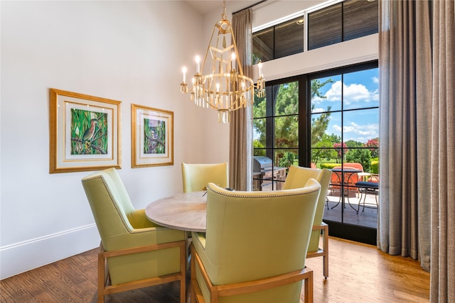 2307 Cedar Elm Ter, Westlake, TX 76262 - dining area featuring a chandelier, wood finished floors, and a towering ceiling