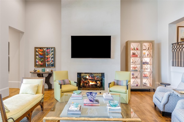 2307 Cedar Elm Ter, Westlake, TX 76262 - living area with wood finished floors and a lit fireplace