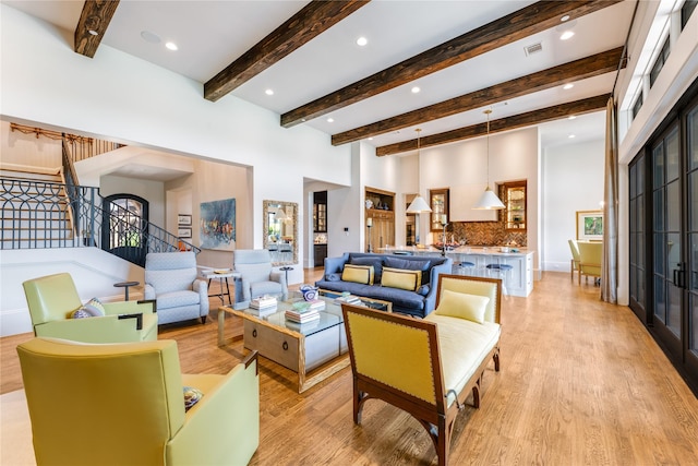 2307 Cedar Elm Ter, Westlake, TX 76262 - living room with light wood finished floors, a towering ceiling, beamed ceiling, stairway, and recessed lighting