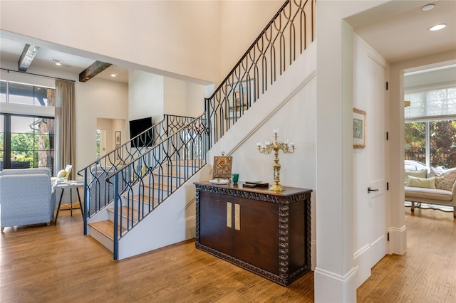 2307 Cedar Elm Ter, Westlake, TX 76262 - stairs with wood finished floors, a towering ceiling, beam ceiling, and recessed lighting