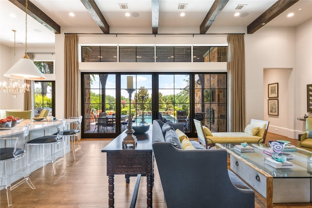 2307 Cedar Elm Ter, Westlake, TX 76262 - living room featuring wood finished floors, beamed ceiling, a chandelier, recessed lighting, and a high ceiling