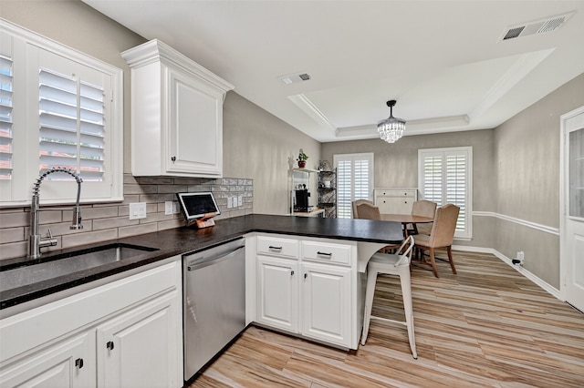 218 Bryant St, Pottsboro, TX 75076 - kitchen featuring stainless steel dishwasher, tasteful backsplash, a peninsula, a chandelier, and light wood-style flooring