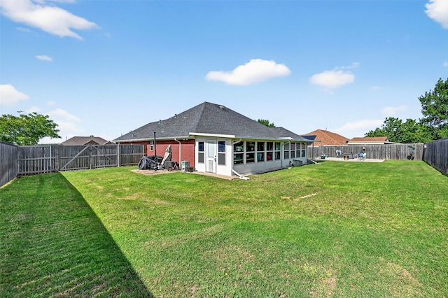 218 Bryant St, Pottsboro, TX 75076 - rear view of house with a fenced backyard, a sunroom, roof with shingles, and brick siding