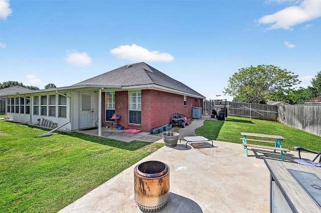 218 Bryant St, Pottsboro, TX 75076 - rear view of house with a patio area, a fire pit, a fenced backyard, brick siding, and roof with shingles