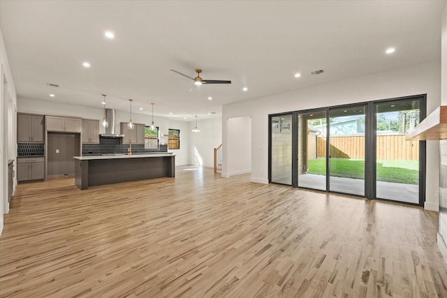 1030 Parkview Ave, Dallas, TX 75223 - living room featuring recessed lighting, light wood-style flooring, ceiling fan, and stairs