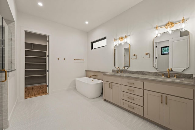 1030 Parkview Ave, Dallas, TX 75223 - bathroom featuring a stall shower, double vanity, a freestanding bath, recessed lighting, and a spacious closet