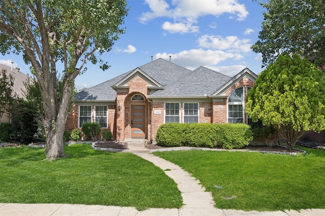 10412 Harris Ct, Irving, TX 75063 - view of front of property with brick siding, a front lawn, and roof with shingles