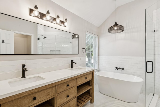 10412 Harris Ct, Irving, TX 75063 - full bathroom with tile walls, a freestanding bath, a stall shower, vaulted ceiling, and double vanity