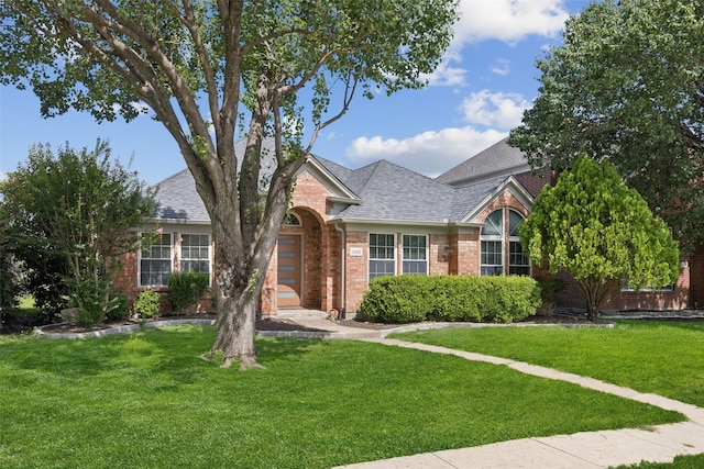 10412 Harris Ct, Irving, TX 75063 - view of front of home featuring brick siding, a front lawn, and roof with shingles