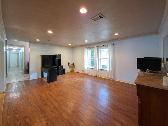 5624 Charlott St, Fort Worth, TX 76112 - unfurnished living room with recessed lighting, wood finished floors, and ornamental molding