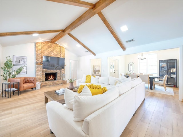 2219 Timberwood, Carrollton, TX 75006 - living area featuring a chandelier, light wood-style floors, and a brick fireplace