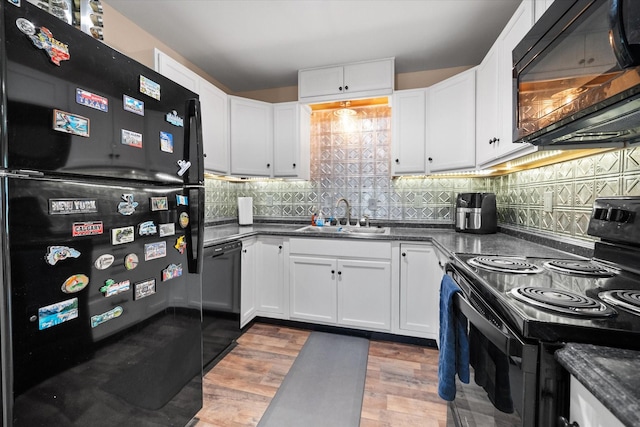 336 Arrowhead St, Fort Worth, TX 76108 - kitchen with black appliances, dark countertops, light wood-type flooring, and white cabinetry