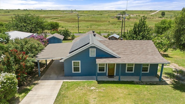 336 Arrowhead St, Fort Worth, TX 76108 - view of front of house featuring an attached carport, driveway, roof mounted solar panels, covered porch, and a front lawn
