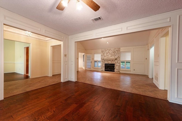 1115 Shady Oak Trl, Mansfield, TX 76063 - unfurnished living room featuring dark wood-style floors, a ceiling fan, a textured ceiling, and a fireplace