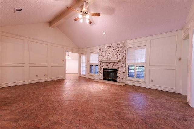 1115 Shady Oak Trl, Mansfield, TX 76063 - unfurnished living room featuring a decorative wall, ceiling fan, a stone fireplace, and a textured ceiling
