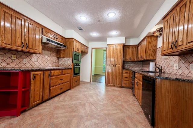 1115 Shady Oak Trl, Mansfield, TX 76063 - kitchen with under cabinet range hood, stainless steel appliances, a textured ceiling, brown cabinetry, and recessed lighting