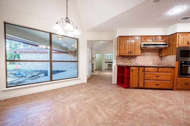 1115 Shady Oak Trl, Mansfield, TX 76063 - kitchen featuring stainless steel appliances, dark countertops, under cabinet range hood, brown cabinetry, and vaulted ceiling