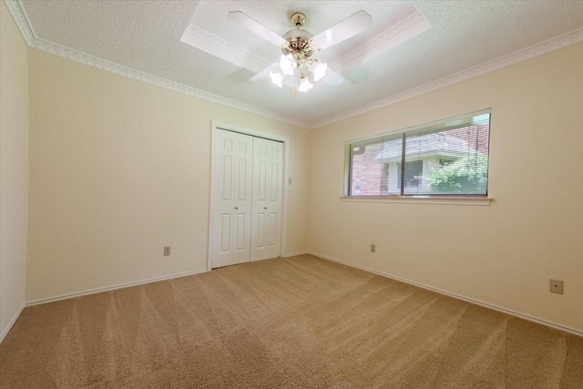1115 Shady Oak Trl, Mansfield, TX 76063 - unfurnished bedroom with light colored carpet, crown molding, a closet, a textured ceiling, and a ceiling fan