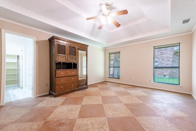 1115 Shady Oak Trl, Mansfield, TX 76063 - empty room featuring a tray ceiling, ornamental molding, and ceiling fan