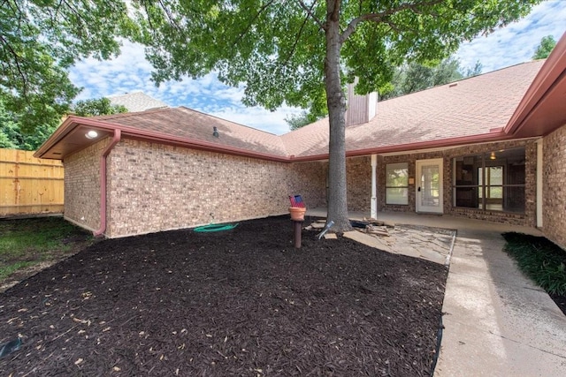 1115 Shady Oak Trl, Mansfield, TX 76063 - back of house featuring brick siding, a shingled roof, a patio area, and a chimney