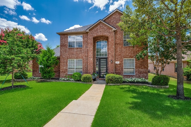 7851 Quiet Meadow Ln, Frisco, TX 75033 - traditional home featuring a front yard, brick siding, and roof with shingles