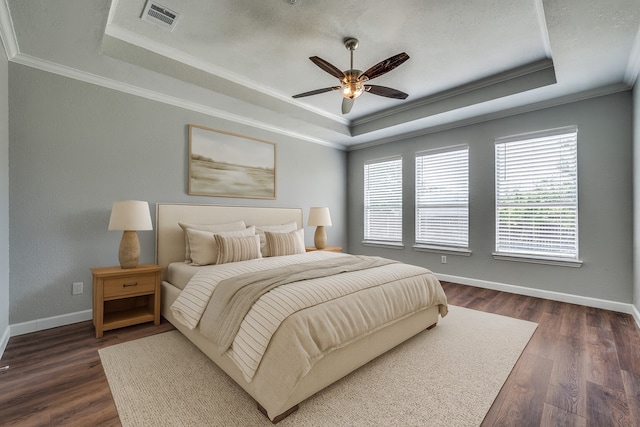 7851 Quiet Meadow Ln, Frisco, TX 75033 - bedroom with a raised ceiling, crown molding, dark wood finished floors, and ceiling fan