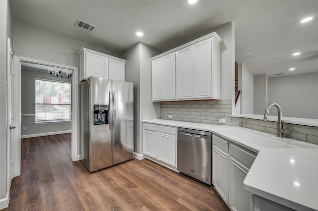 7851 Quiet Meadow Ln, Frisco, TX 75033 - kitchen featuring stainless steel appliances, decorative backsplash, light countertops, dark wood-type flooring, and recessed lighting