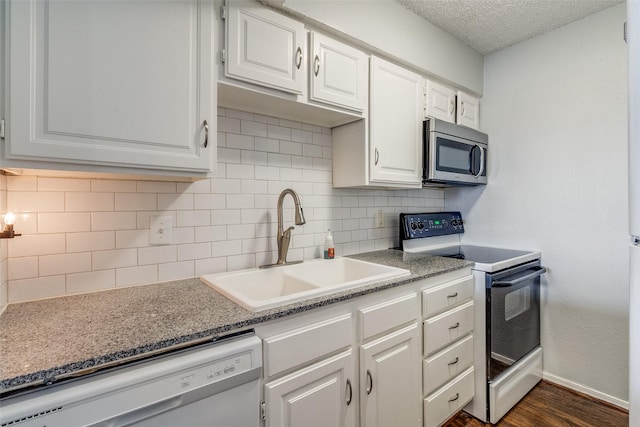 5757 E University Blvd Unit 22T, Dallas, TX 75206 - kitchen with stainless steel microwave, electric stove, dishwasher, white cabinets, and backsplash